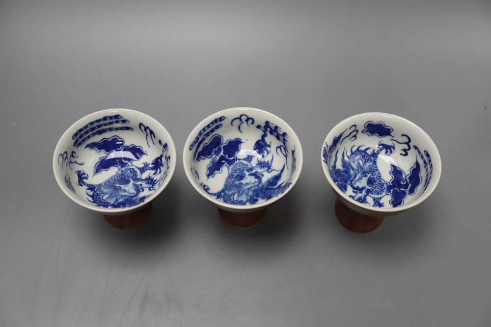 Three Chinese dragon stem cups, with blue and white interior, height 9cm